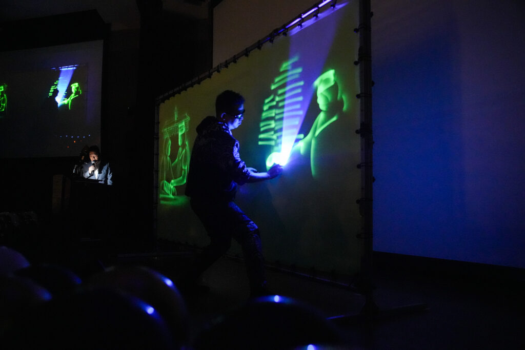 Live light-art performance on stage at the Nurses Day 2025 celebration